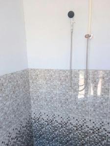 a bathroom with a shower with a glass door at Aidar Yurt Camp in Taldy