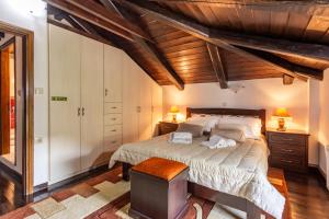 a bedroom with a large bed and wooden ceilings at Xigia Beach Residence villas in Orthoniaí +43 photos