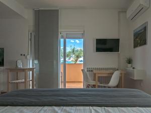 a bedroom with a bed and a table and chairs at Apartments Nino 1 in Zadar