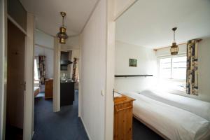 a bedroom with two beds and a window at Hanzehuis Appartementen in Stavoren +16 photos