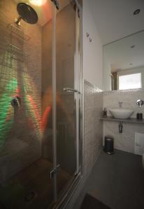 uma casa de banho com um chuveiro e um lavatório. em Palazzo Torre Apartment em Palermo