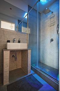 a bathroom with a sink and a shower at Palazzo Torre Apartment in Palermo