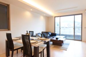 a living room with a table and a couch at Kyoto river side modern House in Kyoto