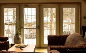 a living room with sliding glass doors and a table at Timber House Resort in Brighton