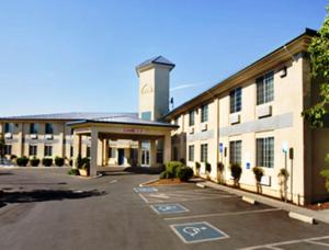 an empty parking lot in front of a building at Ramada by Wyndham Williams in Williams