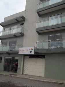a apartment building with a sign for a pet shop at Beija - Flor Hotel in Ipiaú