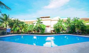 a swimming pool in front of a building at Savoy Hotel Boutique in Las Terrenas