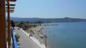 a view of a beach with people in the water at Papas Rooms on the Seafront in Oreoí