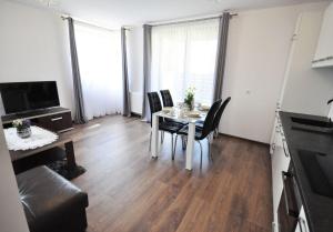 a dining room with a table and chairs in a room at Apartament Parkowy in Rabka-Zdrój