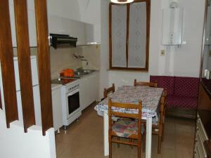 a small kitchen with a table and a stove at La casa sul mare in Riva Ligure