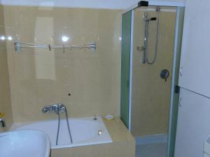 a bathroom with a shower and a tub and a sink at La casa sul mare in Riva Ligure