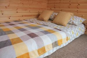 a bed in a room with a wooden wall at Howe of Torbeg in Ballater