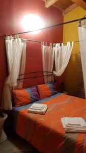 a bedroom with a bed with white curtains at La Locanda dei Cavalieri Affittacamere in Lugagnano Val dʼArda