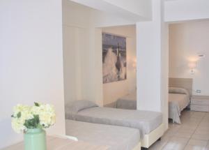 Postel nebo postele na pokoji v ubytování All'Etrusconia Hotel Castagneto Carducci