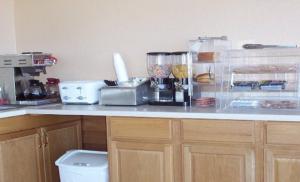 a kitchen counter with a counter top with some food at Stagecoach Motel in La Junta