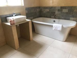 a bathroom with a white tub and a sink at 13 on 2nd Hermanus in Hermanus