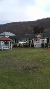 a house with a car parked in front of it at Clarysville Motel in Frostburg