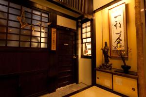 an entrance to a room with a door and a window at Kimi Ryokan in Tokyo