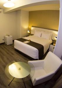Postel nebo postele na pokoji v ubytování LimaQ Hotel