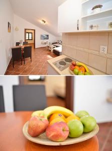 um prato de fruta numa mesa numa cozinha em Apartment Atina em Kotor