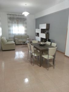a living room with a dining room table and chairs at Villa Fiorella in Sciacca