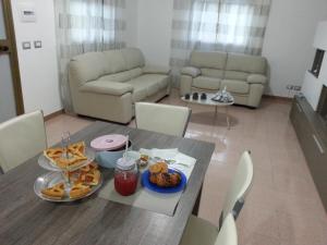 a living room with a table with food on it at Villa Fiorella in Sciacca