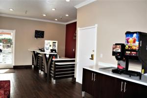a hair salon with a barber shop with a tv at Americas Best Value Inn - Milpitas in Milpitas