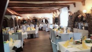 a dining room with white tables and chairs at Hotel-Restaurant Haus Nattkemper in Hamm