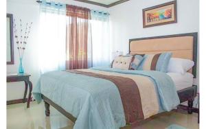 a bedroom with a bed with pillows and a window at Coconut Shell At Turtle Towers in Ocho Rios