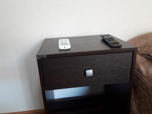 a black table with two remote controls on it at Departamento Maipú in Paraná