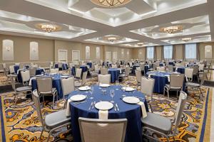 a ballroom with tables and chairs in a room at The Hancock Hotel in Findlay