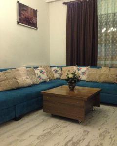 a blue couch in a living room with a coffee table at Zübeyde Hanım Homes in Izmir