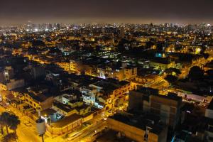 a view of a city at night at Peruvian Apartment in Lima