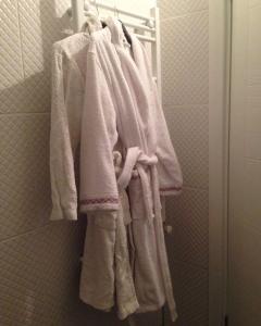 a group of towels hanging on a rack in a bathroom at Zübeyde Hanım Homes in Izmir