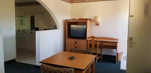 a kitchen with a table and a tv in a room at Night Inn in Globe