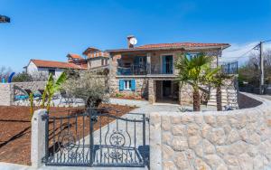 a house with a gate and a stone wall at Old Stone House Apartment With A Heated Pool in Polje