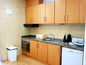 a kitchen with wooden cabinets and a sink at Enjoy Oporto Flats in Porto +24 photos