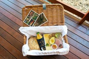 a wicker basket with food in it on a deck at Witches Falls Cottages in Mount Tamborine