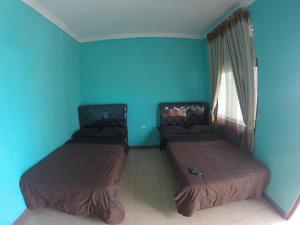 Ein Bett oder Betten in einem Zimmer der Unterkunft Omah Sundak Homestay