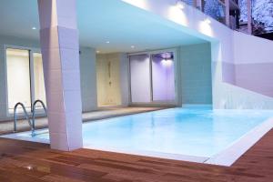 a large swimming pool in the middle of a building at L'Hotel in Rimini