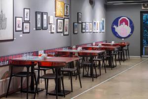 a row of tables in a restaurant with pictures on the wall at Nuru Ziya Residences in Istanbul
