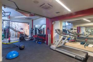 a gym with a lot of treadmills and machines at Nuru Ziya Residences in Istanbul