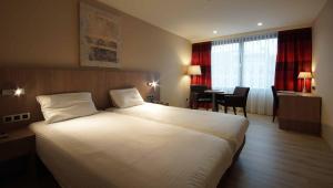 Postel nebo postele na pokoji v ubytování De Keyser Hotel