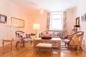 a living room with a couch and chairs and a table at Villa Adolphine in Rottach-Egern
