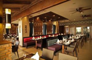 a dining room with tables and chairs in a restaurant at The Bellevue Resort in Panglao Island