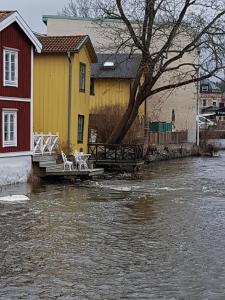a boat that is in the water near a house at Hvilan V-hem Norrtälje AB in Norrtälje