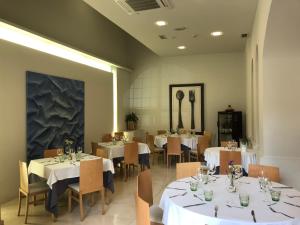 a dining room with tables and chairs with white tablecloths at La Merced de la Concordia in Tarazona de Aragón