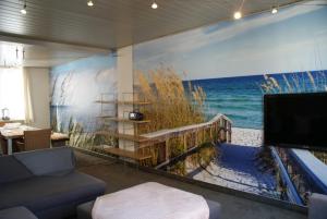a living room with a large painting of the ocean at Clos Normand in De Panne