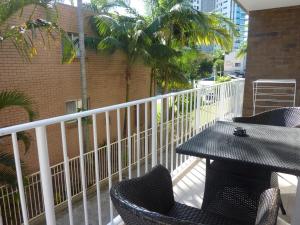 a patio area with a patio table and chairs at Jadran Motel & El Jays Holiday Lodge in Gold Coast