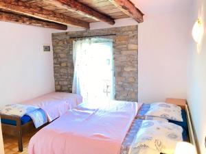 two beds in a room with a window at Istrian House in Portorož